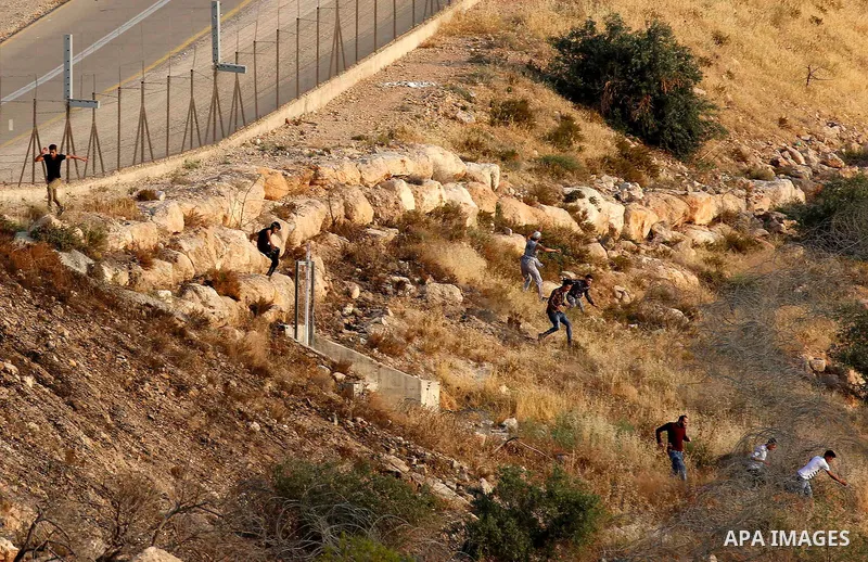 Palestinians try to make their way to attend the third Friday prayer of the holy fasting month of Ramadan in Jerusalem's Al-Aqsa mosque, after Israeli police prevented them from crossing to pray, in the West Bank city of...