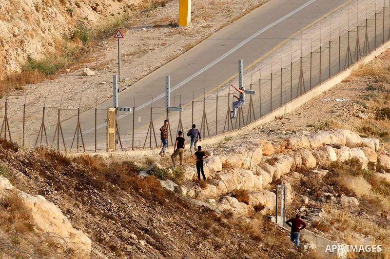 Palestinians try to make their way to attend the third Friday prayer of the holy fasting month of Ramadan in Jerusalem's Al-Aqsa mosque, after Israeli police prevented them from crossing to pray, in the West Bank city of...