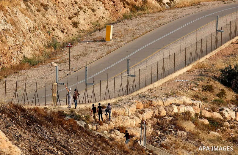 Palestinians try to make their way to attend the third Friday prayer of the holy fasting month of Ramadan in Jerusalem's Al-Aqsa mosque, after Israeli police prevented them from crossing to pray, in the West Bank city of...