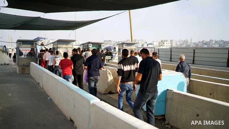 Palestinians make their way through Qalandia checkpoint to attend the third Friday prayer of the holy fasting month of Ramadan in Jerusalem's Al-Aqsa mosque, near Ramallah in the occupied West Bank, on June 1, 2018. Rama...