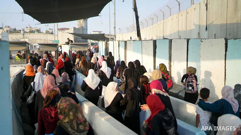 Palestinians make their way through Qalandia checkpoint to attend the third Friday prayer of the holy fasting month of Ramadan in Jerusalem's Al-Aqsa mosque, near Ramallah in the occupied West Bank, on June 1, 2018. Rama...