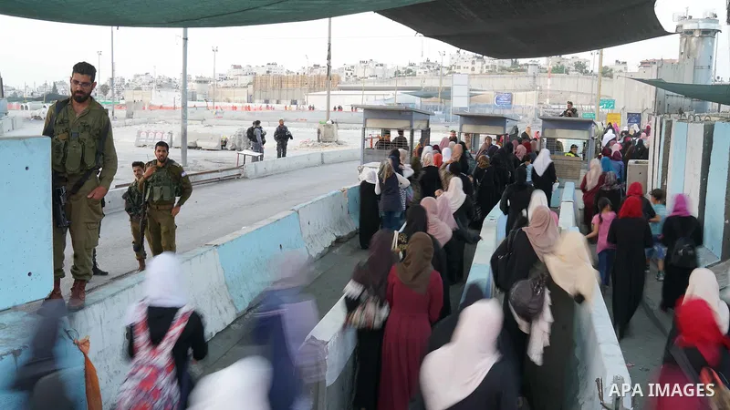 Palestinians make their way through Qalandia checkpoint to attend the third Friday prayer of the holy fasting month of Ramadan in Jerusalem's Al-Aqsa mosque, near Ramallah in the occupied West Bank, on June 1, 2018. Rama...