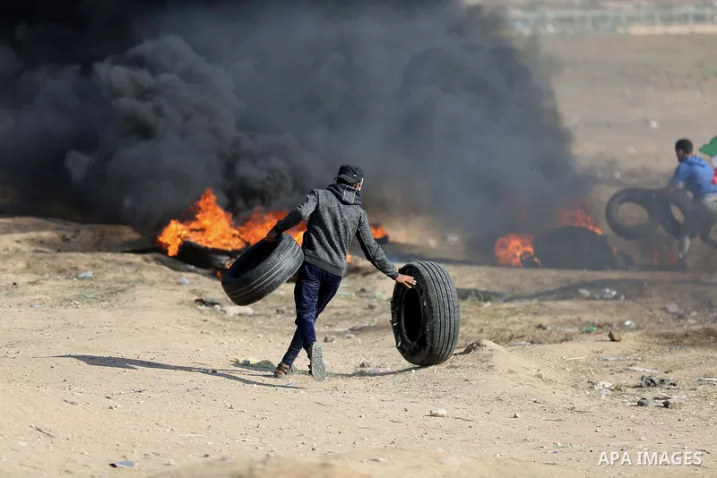 Palestinian protesters gather during clashes with Israeli security froces in a tent city protest where Palestinians demand the right to return to their homeland and against U.S. embassy move to Jerusalem at the Israel-Ga...