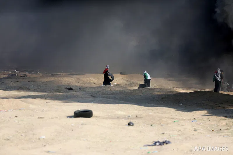 Palestinian protesters gather during clashes with Israeli security froces in a tent city protest where Palestinians demand the right to return to their homeland and against U.S. embassy move to Jerusalem at the Israel-Ga...