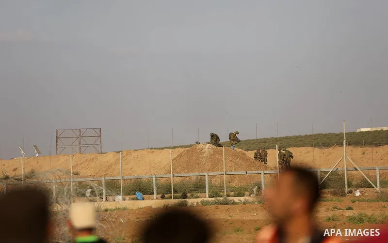 Palestinian protesters gather during clashes with Israeli security froces in a tent city protest where Palestinians demand the right to return to their homeland and against U.S. embassy move to Jerusalem at the Israel-Ga...