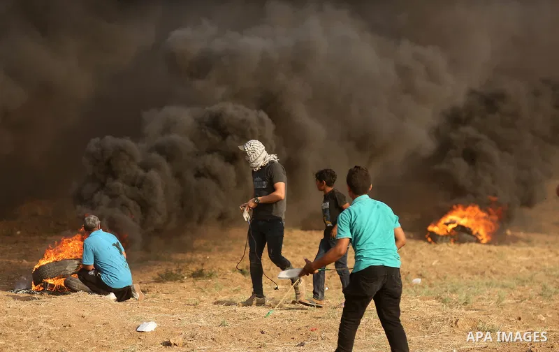 Palestinian protesters gather during clashes with Israeli security froces in a tent city protest where Palestinians demand the right to return to their homeland and against U.S. embassy move to Jerusalem at the Israel-Ga...