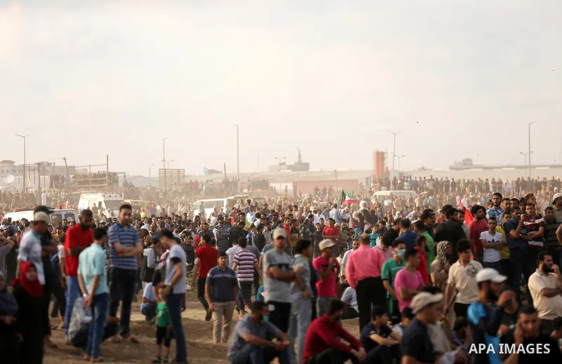 Palestinian protesters gather during clashes with Israeli security froces in a tent city protest where Palestinians demand the right to return to their homeland and against U.S. embassy move to Jerusalem at the Israel-Ga...