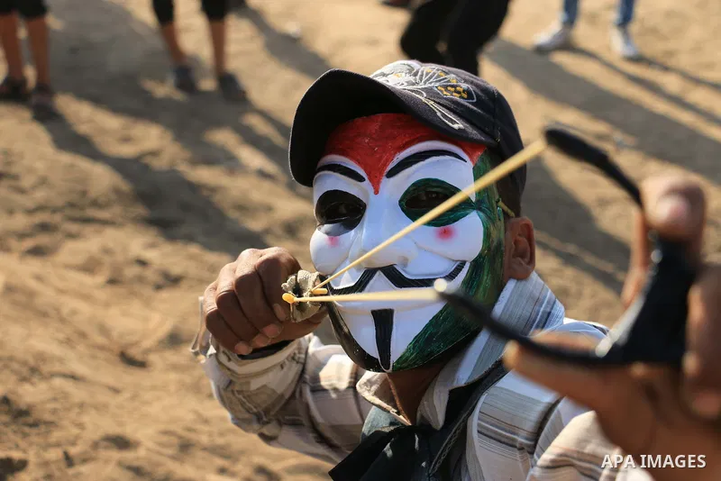 Palestinian protesters gather during clashes with Israeli security froces in a tent city protest where Palestinians demand the right to return to their homeland and against U.S. embassy move to Jerusalem at Israel-Gaza b...