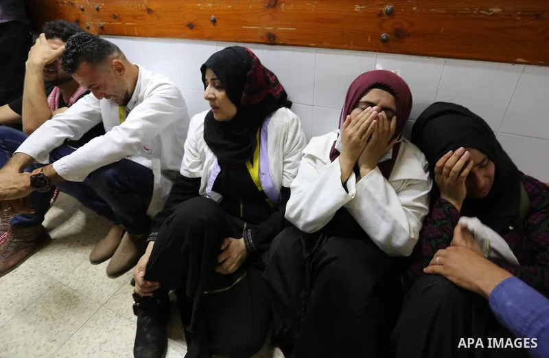Colleagues of Palestinian medic Razan al-Najar, 21, who was killed during a protest at the Israel-Gaza border, react at a hospital in Khan Younis in the southern Gaza Strip, on June 1, 2018. Photo by Ashraf Amra