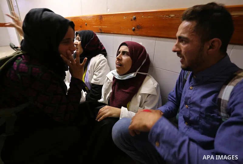 Colleagues of Palestinian medic Razan al-Najar, 21, who was killed during a protest at the Israel-Gaza border, react at a hospital in Khan Younis in the southern Gaza Strip, on June 1, 2018. Photo by Ashraf Amra