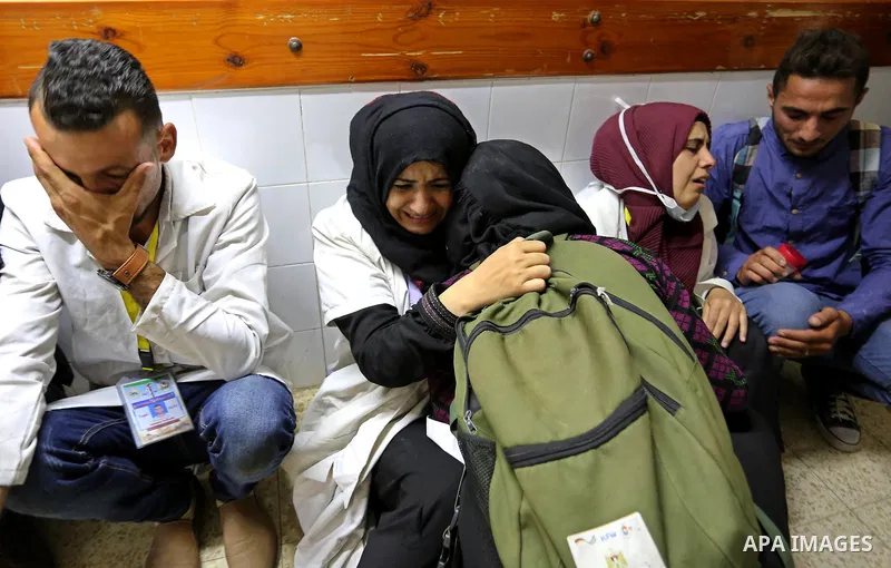 Colleagues of Palestinian medic Razan al-Najar, 21, who was killed during a protest at the Israel-Gaza border, react at a hospital in Khan Younis in the southern Gaza Strip, on June 1, 2018. Photo by Ashraf Amra