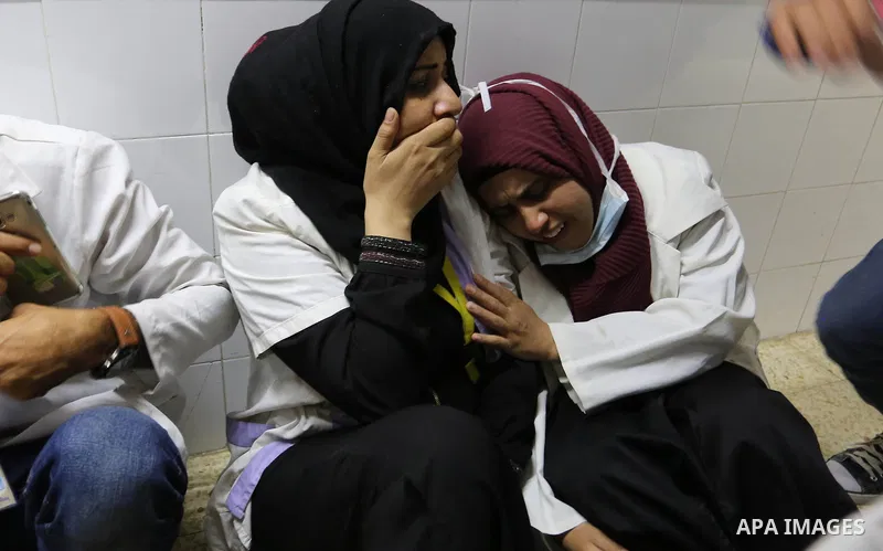 Colleagues of Palestinian medic Razan al-Najar, 21, who was killed during a protest at the Israel-Gaza border, react at a hospital in Khan Younis in the southern Gaza Strip, on June 1, 2018. Photo by Ashraf Amra