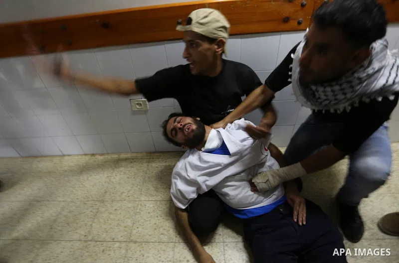 Colleagues of Palestinian medic Razan al-Najar, 21, who was killed during a protest at the Israel-Gaza border, react at a hospital in Khan Younis in the southern Gaza Strip, on June 1, 2018. Photo by Ashraf Amra