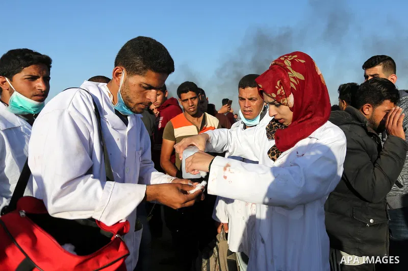 (FILES) This file photo taken on April 1, 2018. shows A Palestinian medical Razan al-Najjar tries to cure herself after she was gas inhaled fired by Israeli security forces, who was killed during a protest at the Israel-...