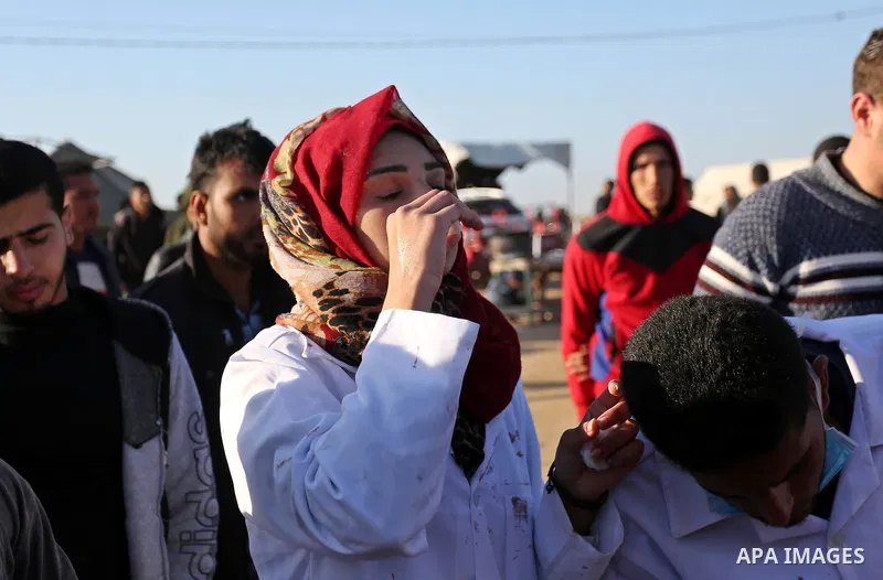 (FILES) This file photo taken on April 1, 2018. shows A Palestinian medical Razan al-Najjar tries to cure herself after she was gas inhaled fired by Israeli security forces, who was killed during a protest at the Israel-...