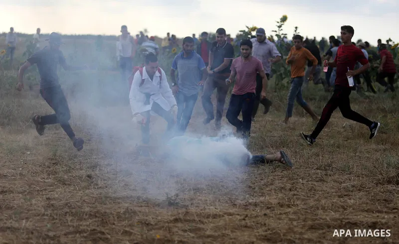 A wounded Palestinian protester is evacuated during clashes with Israeli security froces in a tent city protest where Palestinians demand the right to return to their homeland and against U.S. embassy move to Jerusalem a...