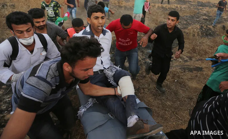 A wounded Palestinian protester is evacuated during clashes with Israeli security froces in a tent city protest where Palestinians demand the right to return to their homeland and against U.S. embassy move to Jerusalem a...