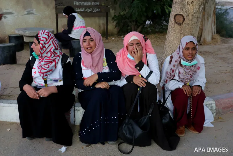 Colleagues of Palestinian medic Razan al-Najar, 21, who was killed during a protest at the Israel-Gaza border, react at a hospital in Khan Younis in the southern Gaza Strip, on June 1, 2018. Photo by Ashraf Amra