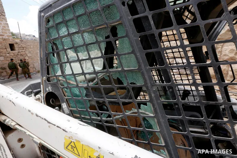 Israeli soldiers gather at the scene of what the Israeli military said was car-ramming attacks by a Palestinian man in the West Bank city of Hebron on June 2, 2018. The Israeli army shot dead Rami Sabarneh, 36, in the Ja...