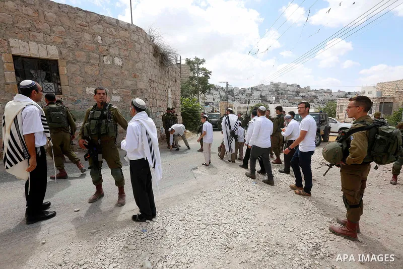 Israeli soldiers gather at the scene of what the Israeli military said was car-ramming attacks by a Palestinian man in the West Bank city of Hebron on June 2, 2018. The Israeli army shot dead Rami Sabarneh, 36, in the Ja...