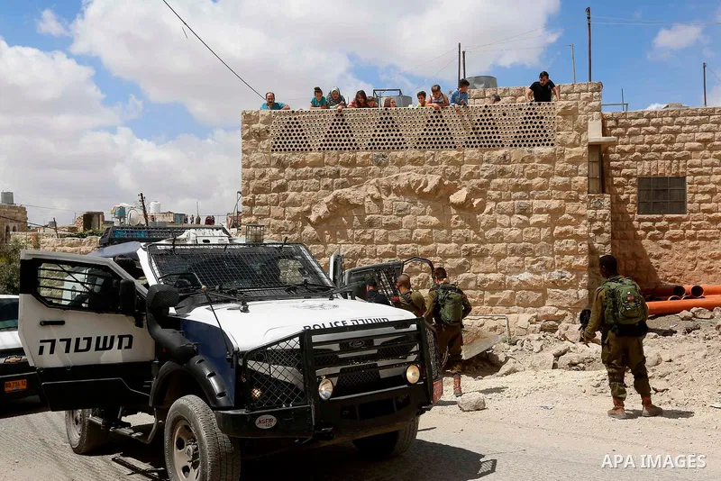 Israeli soldiers gather at the scene of what the Israeli military said was car-ramming attacks by a Palestinian man in the West Bank city of Hebron on June 2, 2018. The Israeli army shot dead Rami Sabarneh, 36, in the Ja...