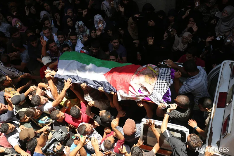 Palestinian mourners carry the body of nurse Razan Al-Najar, 21, during her funeral after she was shot dead by Israeli soldiers, in Khan Younis in the southern Gaza strip on June 2, 2018. Najar, a volunteer medic, was sh...