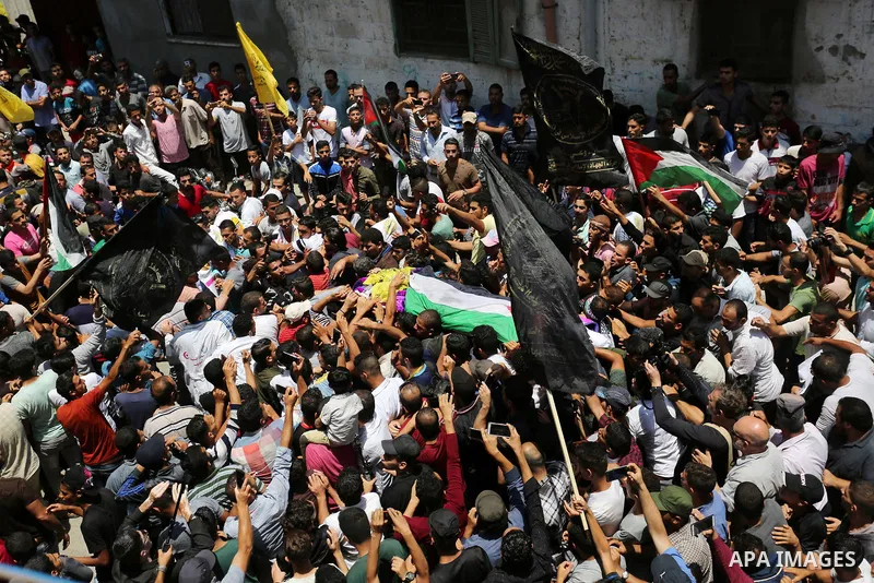 Palestinian mourners carry the body of nurse Razan Al-Najar, 21, during her funeral after she was shot dead by Israeli soldiers, in Khan Younis in the southern Gaza strip on June 2, 2018. Najar, a volunteer medic, was sh...