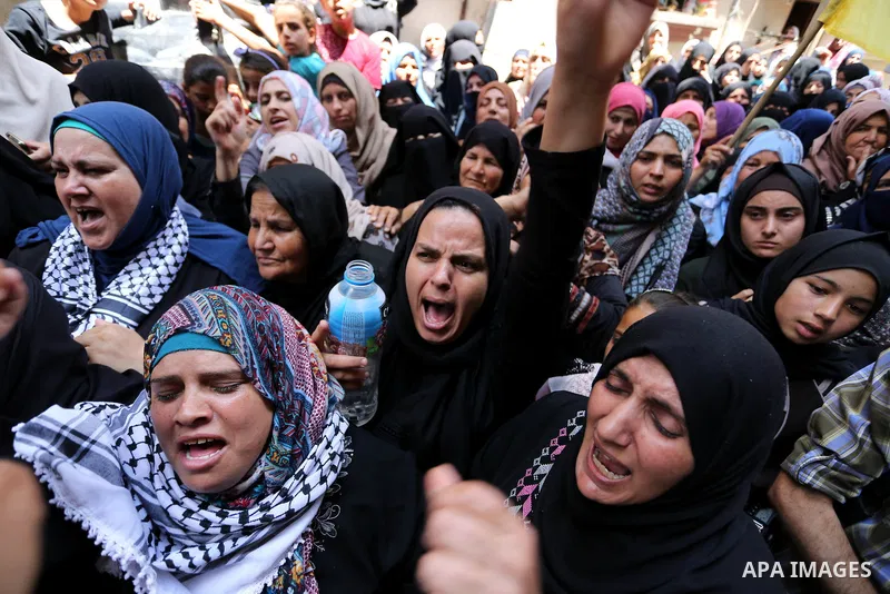 Relatives of Palestinian nurse Razan Al-Najar, 21, mourn during her funeral after she was shot dead by Israeli soldiers, in Khan Younis in the southern Gaza strip on June 2, 2018. Najar, a volunteer medic, was shot by Is...