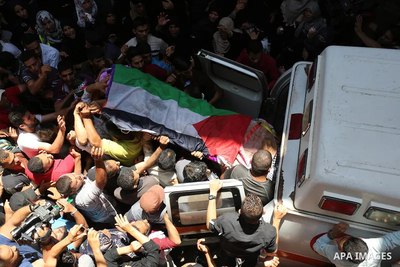 Palestinian mourners carry the body of nurse Razan Al-Najar, 21, during her funeral after she was shot dead by Israeli soldiers, in Khan Younis in the southern Gaza strip on June 2, 2018. Najar, a volunteer medic, was sh...