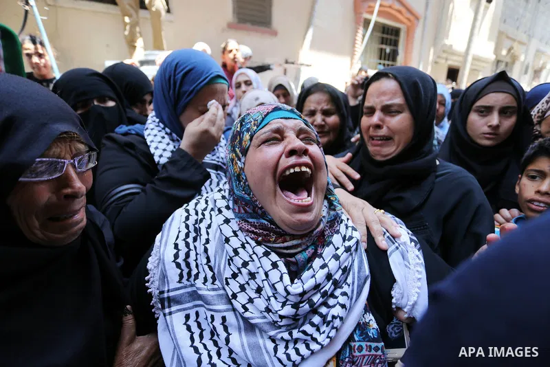 Relatives of Palestinian nurse Razan Al-Najar, 21, mourn during her funeral after she was shot dead by Israeli soldiers, in Khan Younis in the southern Gaza strip on June 2, 2018. Najar, a volunteer medic, was shot by Is...