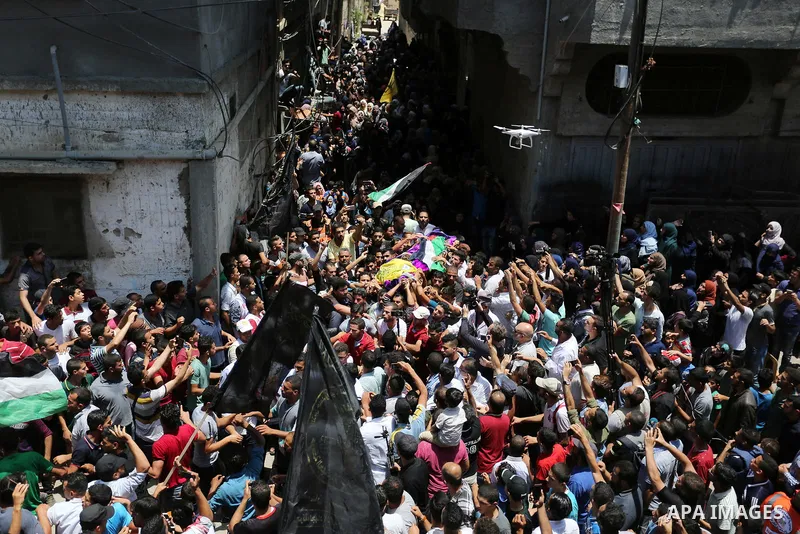 Palestinian mourners carry the body of nurse Razan Al-Najar, 21, during her funeral after she was shot dead by Israeli soldiers, in Khan Younis in the southern Gaza strip on June 2, 2018. Najar, a volunteer medic, was sh...