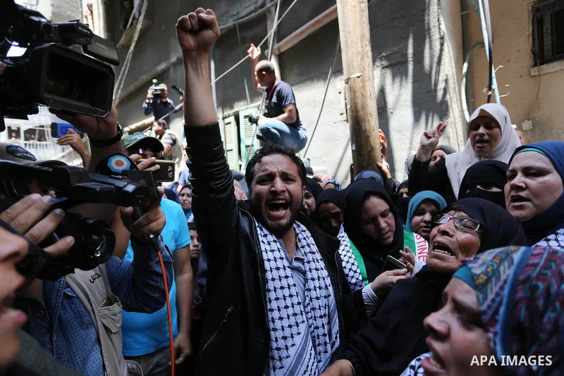 Relatives of Palestinian nurse Razan Al-Najar, 21, mourn during her funeral after she was shot dead by Israeli soldiers, in Khan Younis in the southern Gaza strip on June 2, 2018. Najar, a volunteer medic, was shot by Is...