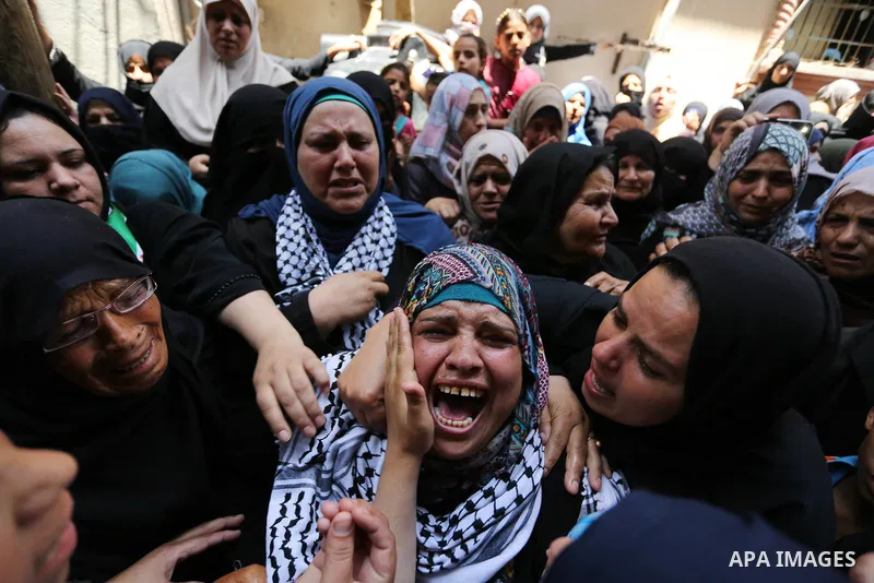 Relatives of Palestinian nurse Razan Al-Najar, 21, mourn during her funeral after she was shot dead by Israeli soldiers, in Khan Younis in the southern Gaza strip on June 2, 2018. Najar, a volunteer medic, was shot by Is...