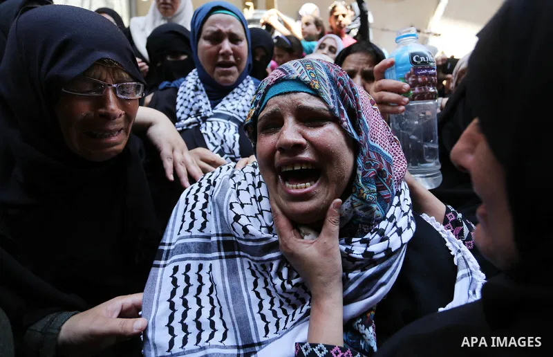 Relatives of Palestinian nurse Razan Al-Najar, 21, mourn during her funeral after she was shot dead by Israeli soldiers, in Khan Younis in the southern Gaza strip on June 2, 2018. Najar, a volunteer medic, was shot by Is...