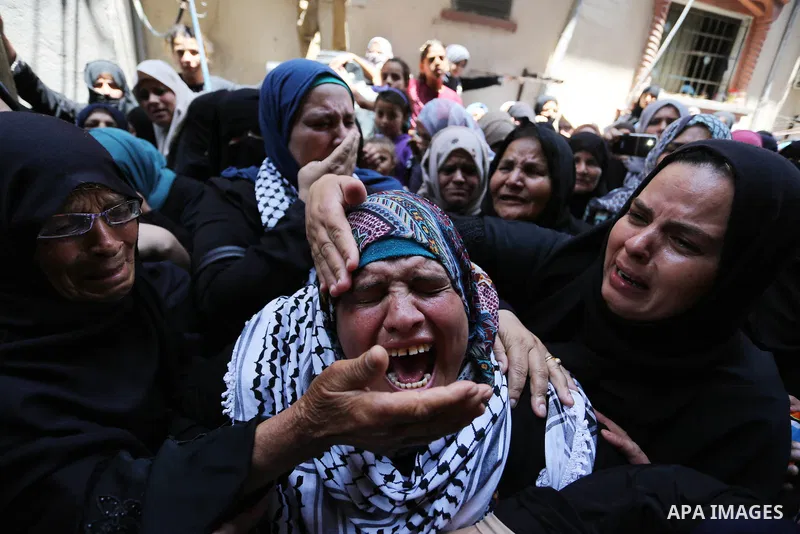 Relatives of Palestinian nurse Razan Al-Najar, 21, mourn during her funeral after she was shot dead by Israeli soldiers, in Khan Younis in the southern Gaza strip on June 2, 2018. Najar, a volunteer medic, was shot by Is...