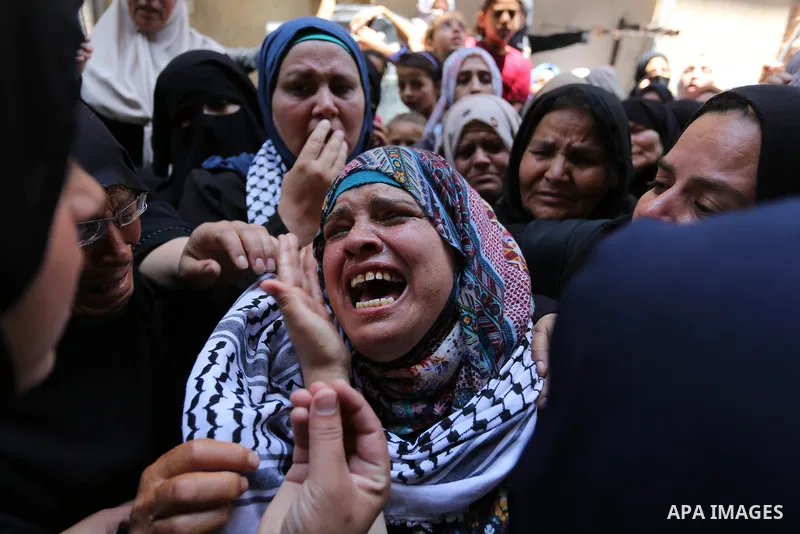 Relatives of Palestinian nurse Razan Al-Najar, 21, mourn during her funeral after she was shot dead by Israeli soldiers, in Khan Younis in the southern Gaza strip on June 2, 2018. Najar, a volunteer medic, was shot by Is...