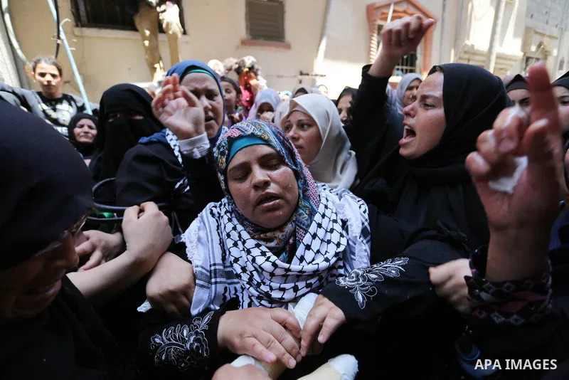 Relatives of Palestinian nurse Razan Al-Najar, 21, mourn during her funeral after she was shot dead by Israeli soldiers, in Khan Younis in the southern Gaza strip on June 2, 2018. Najar, a volunteer medic, was shot by Is...