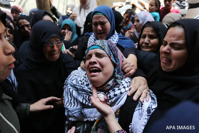 Relatives of Palestinian nurse Razan Al-Najar, 21, mourn during her funeral after she was shot dead by Israeli soldiers, in Khan Younis in the southern Gaza strip on June 2, 2018. Najar, a volunteer medic, was shot by Is...