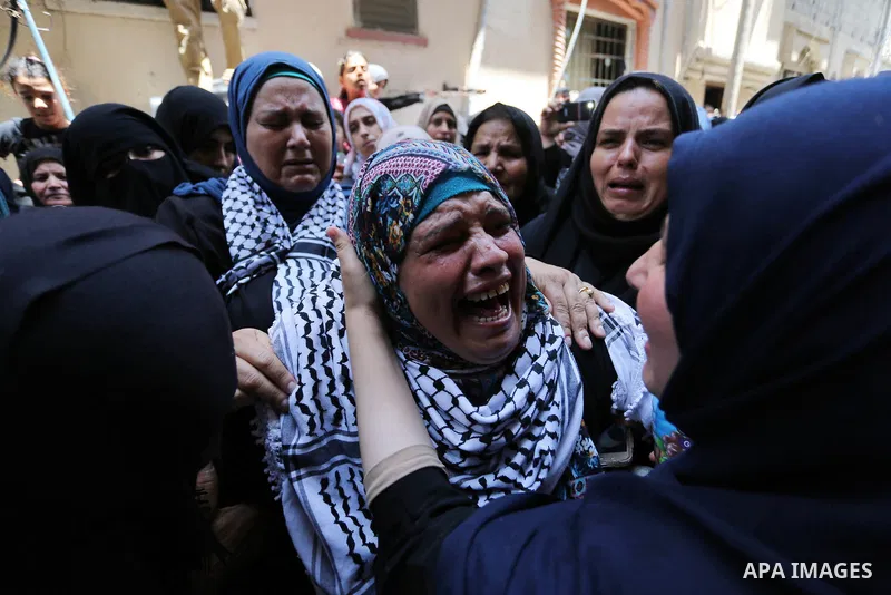 Relatives of Palestinian nurse Razan Al-Najar, 21, mourn during her funeral after she was shot dead by Israeli soldiers, in Khan Younis in the southern Gaza strip on June 2, 2018. Najar, a volunteer medic, was shot by Is...