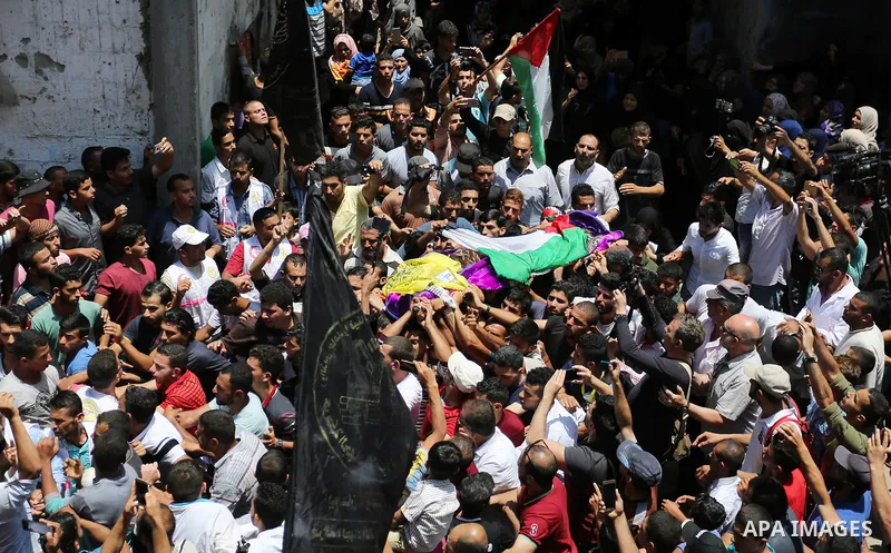 Palestinian mourners carry the body of nurse Razan Al-Najar, 21, during her funeral after she was shot dead by Israeli soldiers, in Khan Younis in the southern Gaza strip on June 2, 2018. Najar, a volunteer medic, was sh...