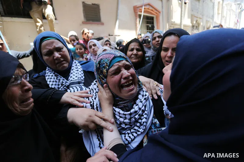 Relatives of Palestinian nurse Razan Al-Najar, 21, mourn during her funeral after she was shot dead by Israeli soldiers, in Khan Younis in the southern Gaza strip on June 2, 2018. Najar, a volunteer medic, was shot by Is...