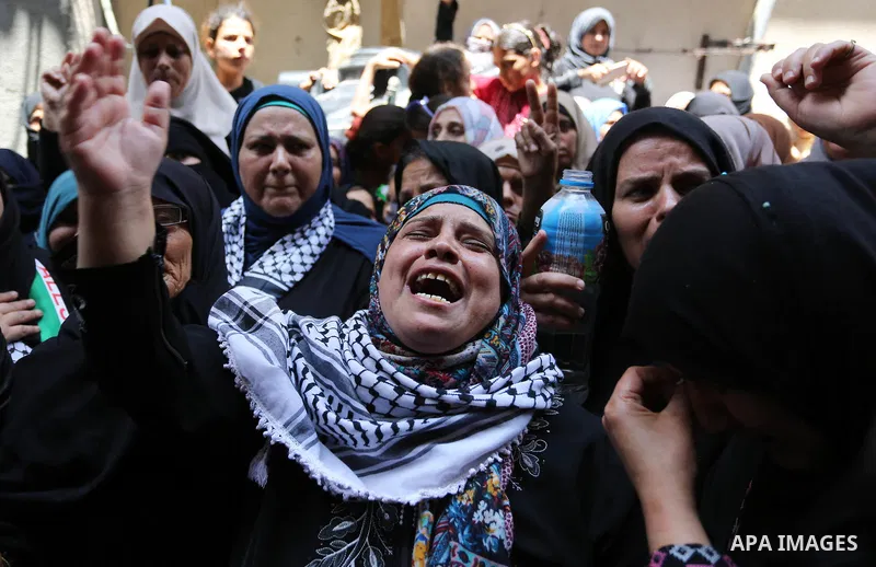 Relatives of Palestinian nurse Razan Al-Najar, 21, mourn during her funeral after she was shot dead by Israeli soldiers, in Khan Younis in the southern Gaza strip on June 2, 2018. Najar, a volunteer medic, was shot by Is...