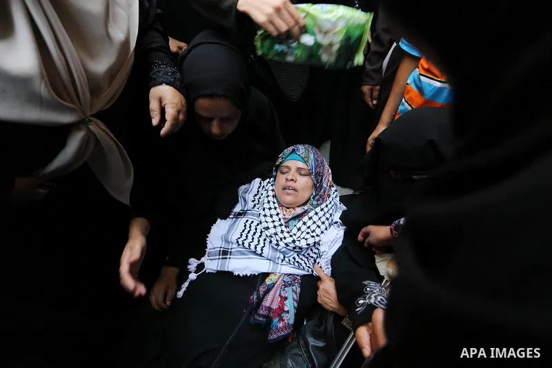 Relatives of Palestinian nurse Razan Al-Najar, 21, mourn during her funeral after she was shot dead by Israeli soldiers, in Khan Younis in the southern Gaza strip on June 2, 2018. Najar, a volunteer medic, was shot by Is...