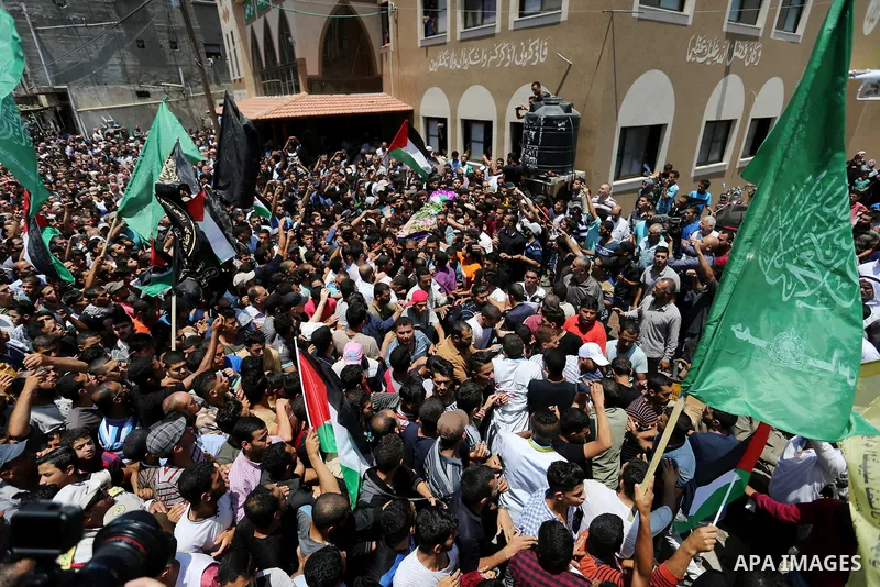 Palestinian mourners carry the body of nurse Razan Al-Najar, 21, during her funeral after she was shot dead by Israeli soldiers, in Khan Younis in the southern Gaza strip on June 2, 2018. Najar, a volunteer medic, was sh...
