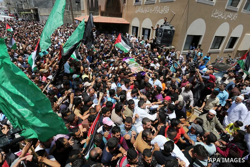 Palestinian mourners carry the body of nurse Razan Al-Najar, 21, during her funeral after she was shot dead by Israeli soldiers, in Khan Younis in the southern Gaza strip on June 2, 2018. Najar, a volunteer medic, was sh...