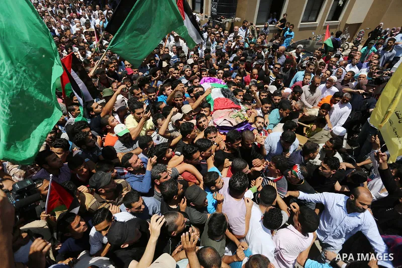 Palestinian mourners carry the body of nurse Razan Al-Najar, 21, during her funeral after she was shot dead by Israeli soldiers, in Khan Younis in the southern Gaza strip on June 2, 2018. Najar, a volunteer medic, was sh...