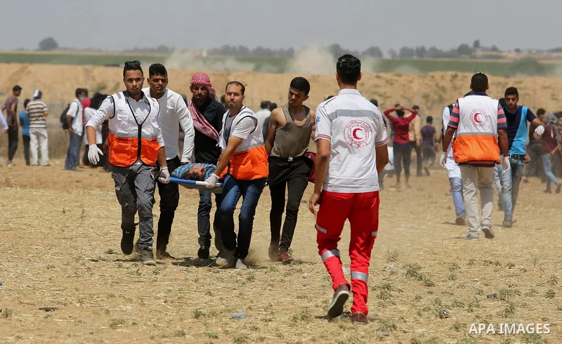 A wounded Palestinian protester is evacuated during clashes with Israeli security froces in a tent city protest where Palestinians demand the right to return to their homeland and against U.S. embassy move to Jerusalem a...