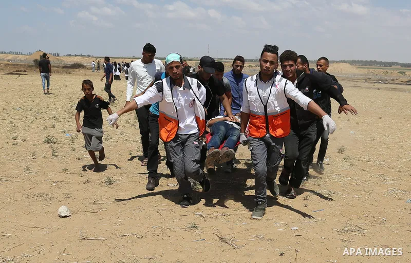 A wounded Palestinian protester is evacuated during clashes with Israeli security froces in a tent city protest where Palestinians demand the right to return to their homeland and against U.S. embassy move to Jerusalem a...