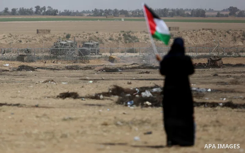 Palestinian protesters gather during clashes with Israeli security froces in a tent city protest where Palestinians demand the right to return to their homeland and against U.S. embassy move to Jerusalem at the Israel-Ga...