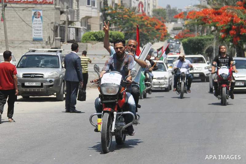 Palestinians ride motorcycles and carry the Palestinian flag during a demonstration organized by the National Authority for Return and Breaking the Siege in Gaza City, June 5, 2018. Photo by Mahmoud Ajour